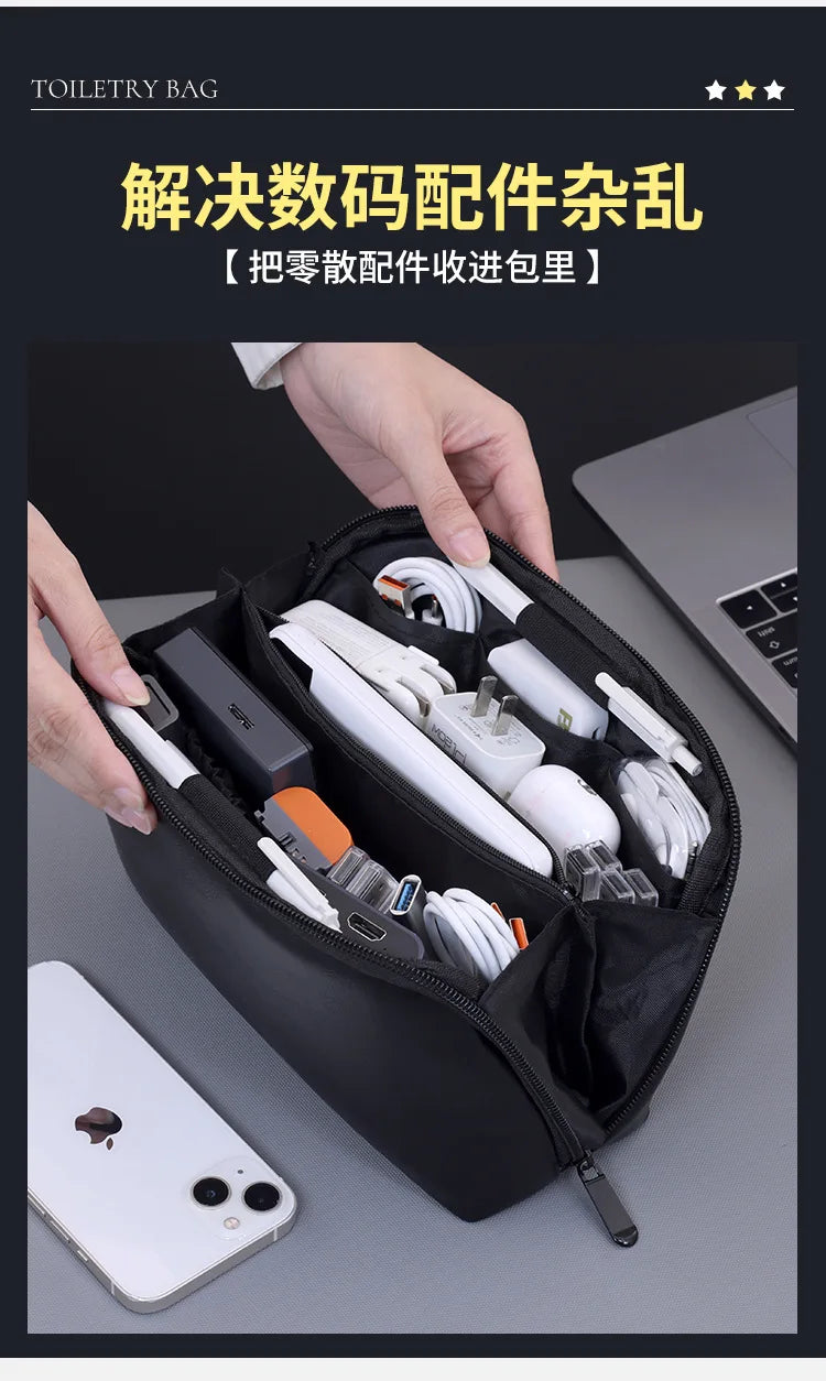 A hand is opening a black toiletry bag organizer revealing various electronic cables and accessories.