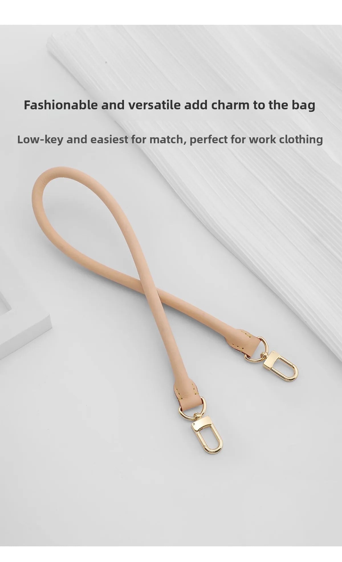 A tan leather replacement shoulder strap with a gold-toned clasp is shown against a white background.