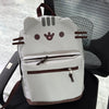 A light gray Pusheen cat canvas backpack with brown accents resting on a black chair.