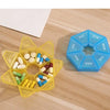 A yellow 7-day weekly pill organizer with compartments filled with pills is shown next to a blue weekly calendar organizer.