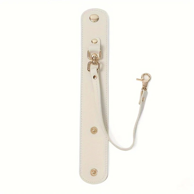 A beige vintage leather glove holder strap with brass hardware and a leather loop.
