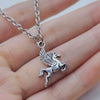 Silver necklace with an engraved Western cowboy boot and hat horseshoe keychain charm