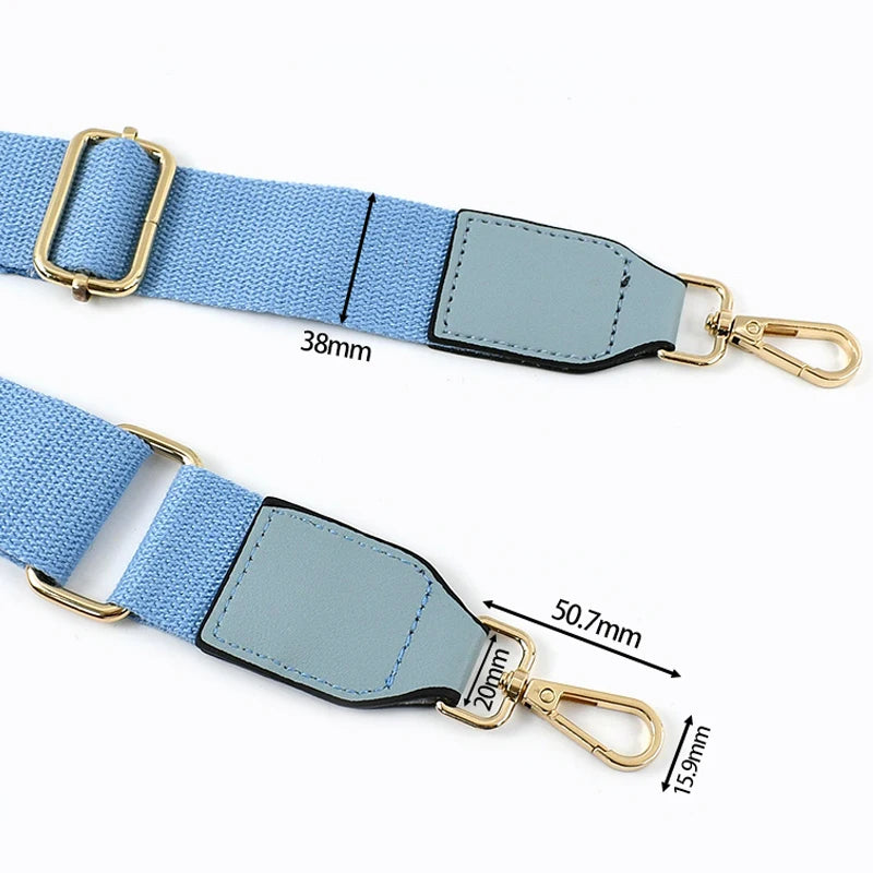 Light blue canvas cotton bag strap with metal hooks and a rectangular leather patch.