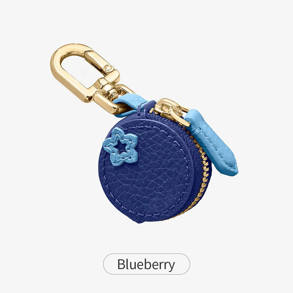 A navy blue coin purse keychain with a star pattern and gold hardware.