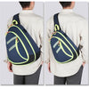 A person is shown wearing a navy blue medical crossbody bag with neon yellow accents over a light-colored shirt.