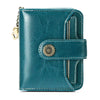 A teal leather wallet with a clasp closure and card slots shown in a close-up view.