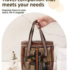 A clear waterproof travel toiletry bag with brown and black striped straps and various grooming products is shown on a white 