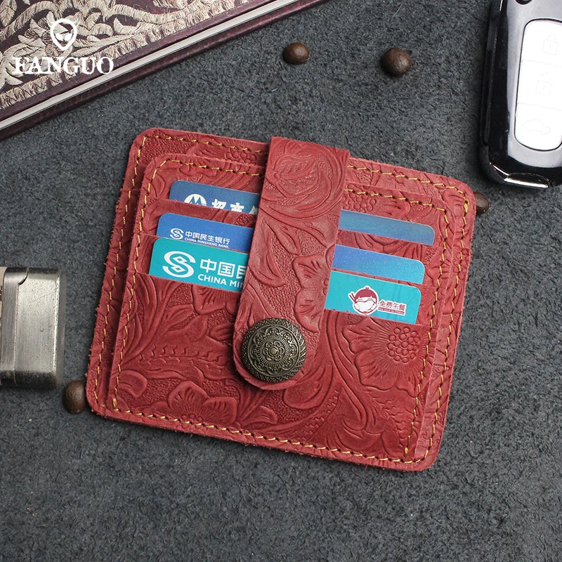 A reddish-brown genuine leather card wallet with a stitched edge and a coin-shaped closure, displaying credit cards.