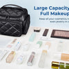 A black quilted multi-compartment travel organizer bag filled with various cosmetics, toiletries, and jewelry.