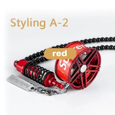 Red alloy wheel hub brake disc rearview mirror pendant with a silver keychain.