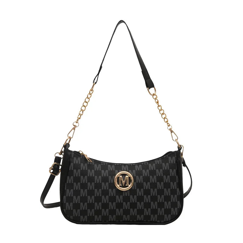 Bolso cruz negro vintage dorado con letra M y correa de cadena larga