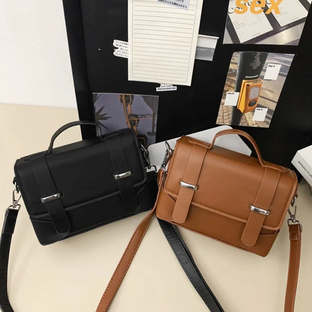 A brown leather minimalist crossbody bag for men displayed on a black background with accompanying paper.