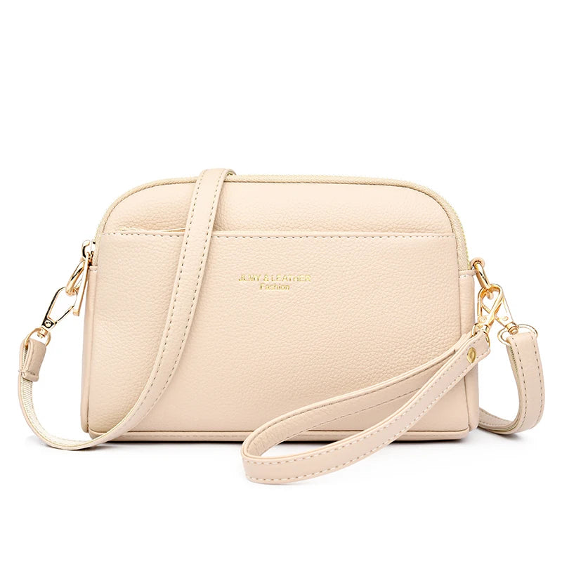 A light beige PU leather trendy shoulder crossbody bag with gold hardware.