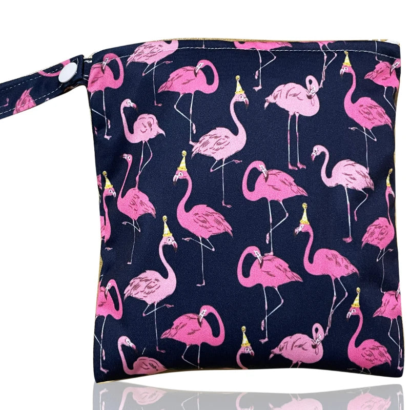 A pack of reusable waterproof snack bags featuring pink flamingos on a navy blue background with a gold trim.