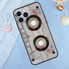 A clear phone case designed to look like a vintage cassette tape featuring tape reels and labels on a light blue background.