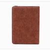 A brown premium PU leather travel passport holder with a snap closure.