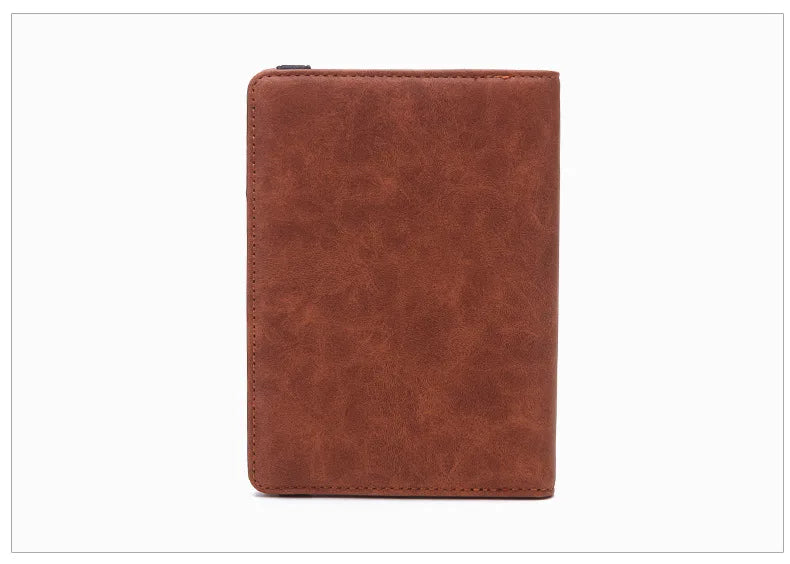A brown premium PU leather travel passport holder with a snap closure.
