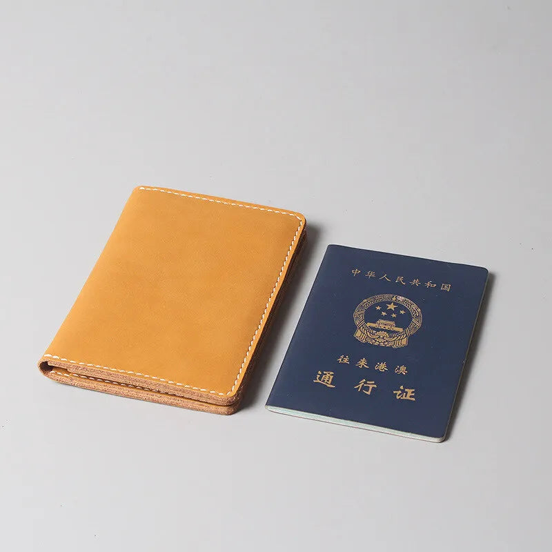 A tan genuine cowhide leather passport and ticket holder with Chinese text on a dark blue card.
