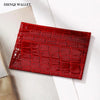 A red crocodile pattern slim card holder wallet displayed on a white background.