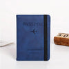 A dark blue passport wallet with a black trim and a silver airplane icon is shown on a white surface.