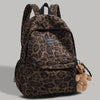 A brown leopard print backpack with black straps and a small teddy bear accessory.