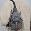 A beige shirt is shown with a black strap attached to a gray patterned crossbody sling bag.