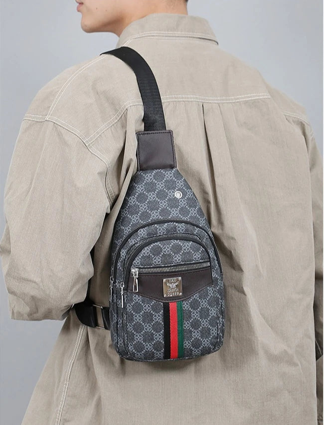 A beige shirt is shown with a black strap attached to a gray patterned crossbody sling bag.
