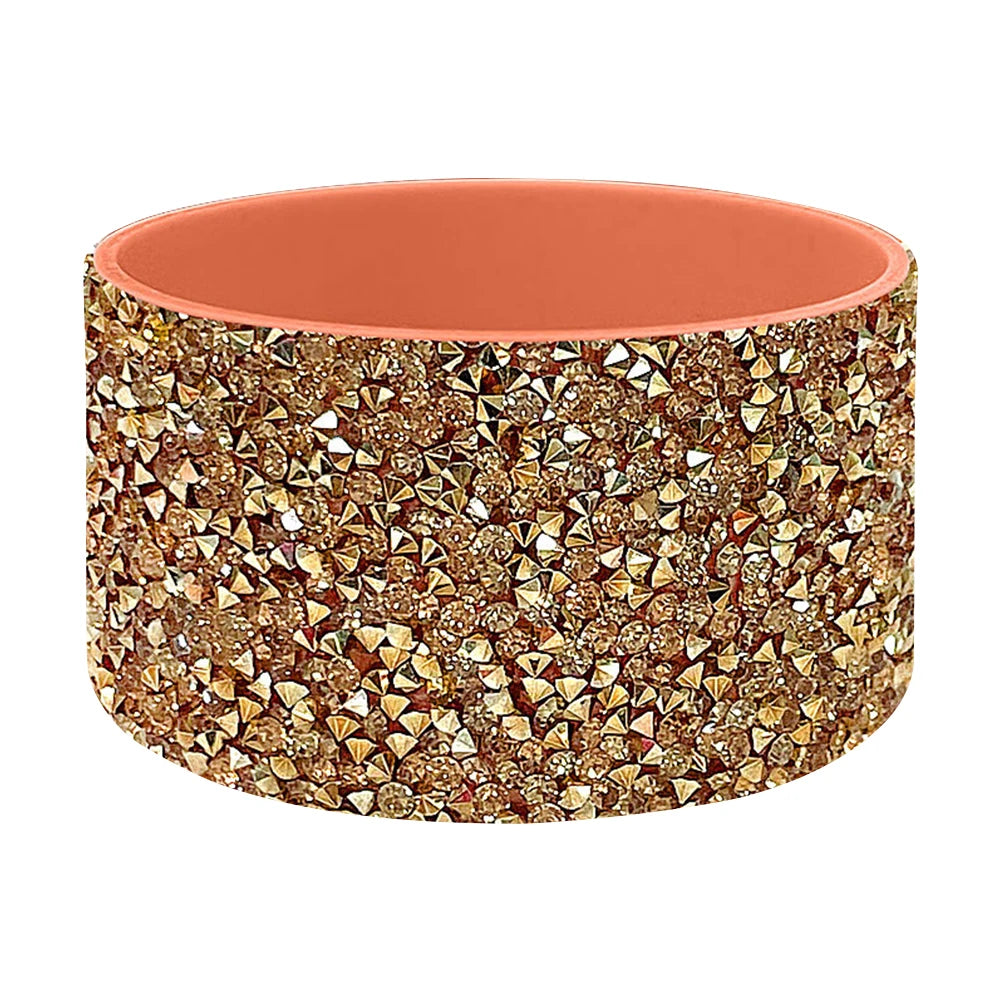 A durable silicone boot sleeve for water bottles in a matte terracotta color with a gold glitter pattern.