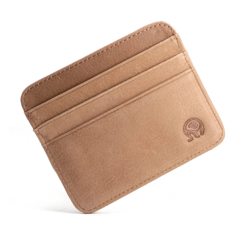 A tan genuine leather slim card holder wallet with a rounded corner and an embossed design.