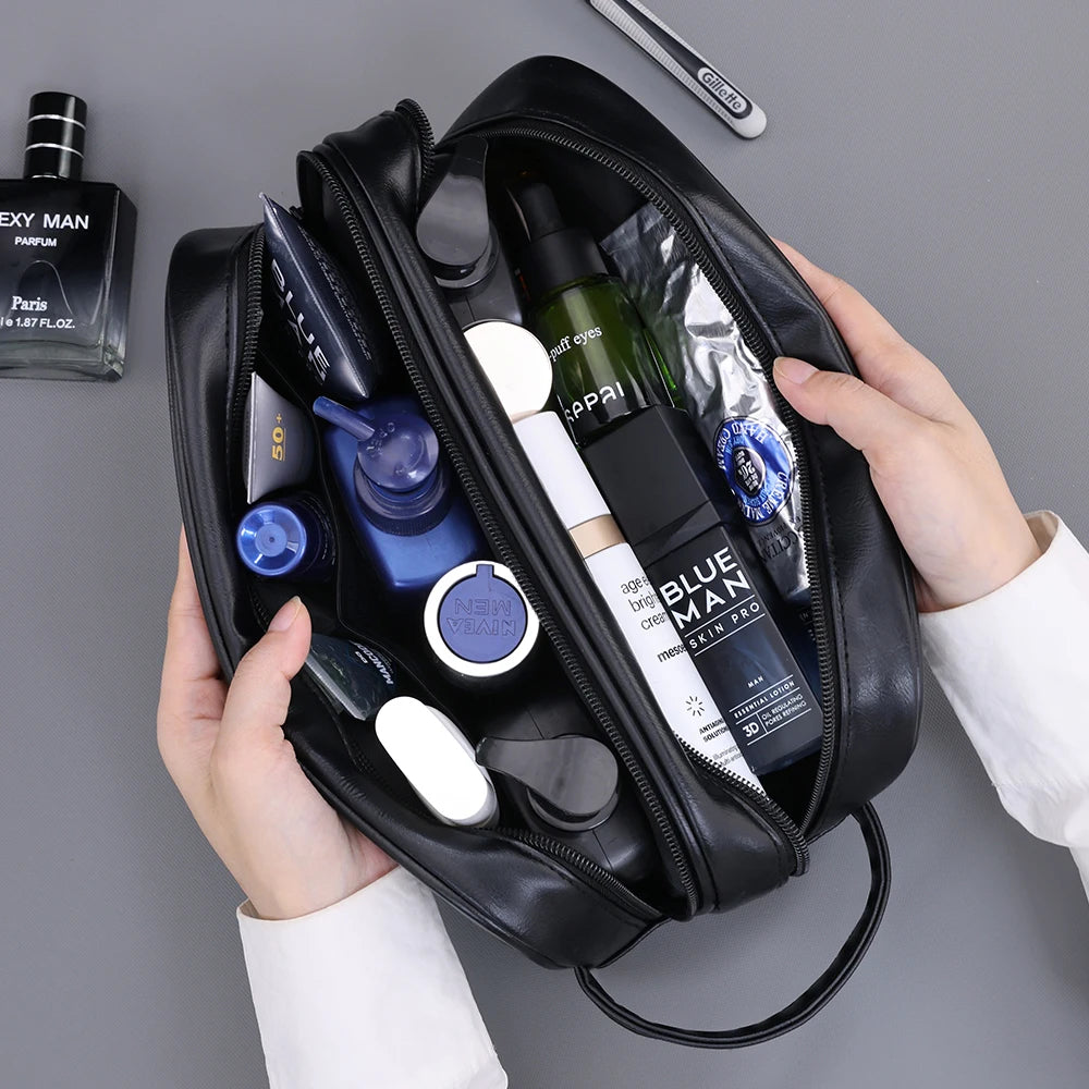 A black premium PU leather toiletry bag for men is shown open, containing various grooming products and a cologne bottle.