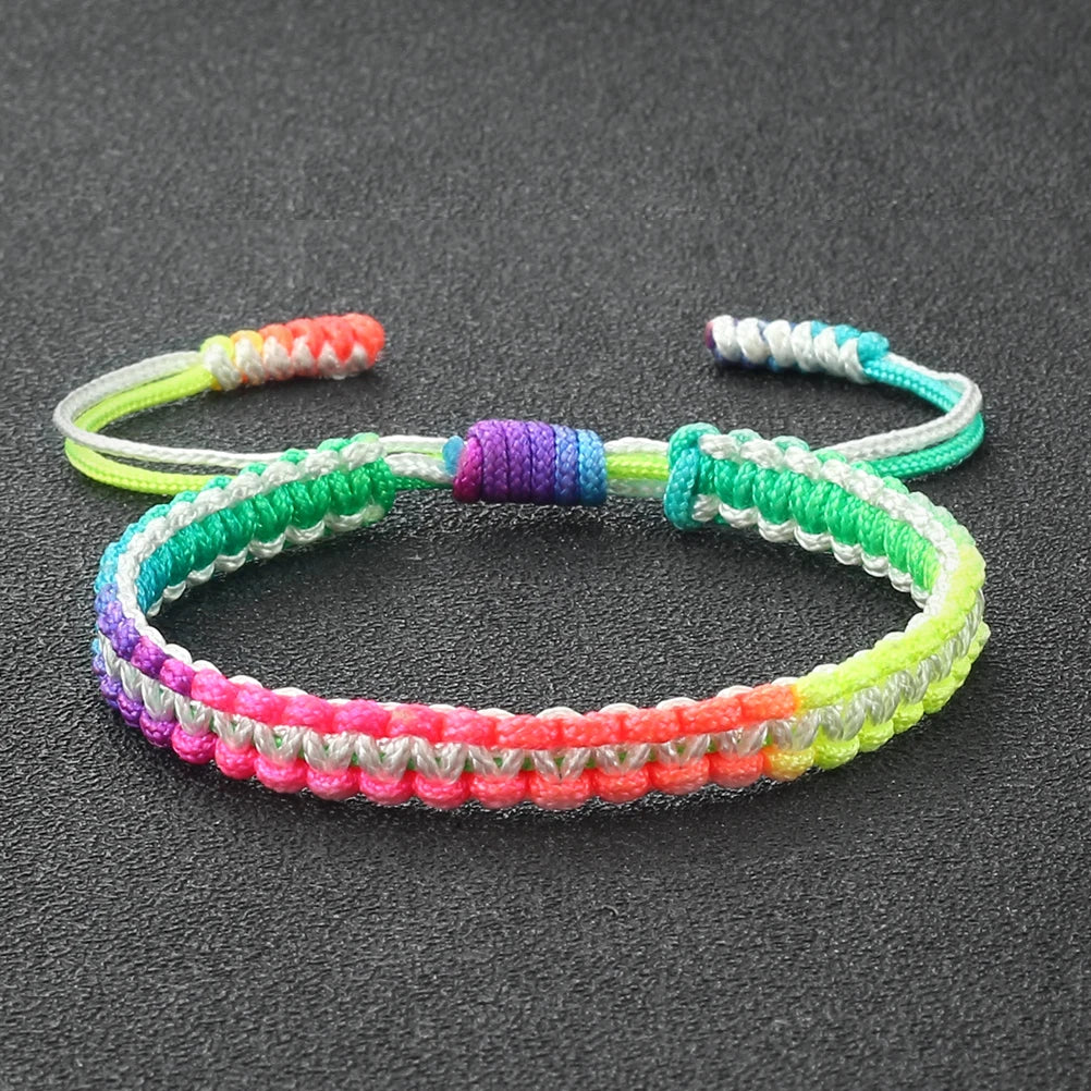 Handmade braided rope bracelet featuring colorful strands of green, purple, pink, and yellow.