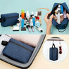 A blue embroidered travel cosmetic bag is shown open, revealing various beauty products and tools.
