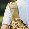 A close-up view of a tan multi-compartment crossbody and chest bag worn on a person's shoulder.