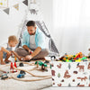A man is assembling a foldable fabric storage basket with handles for organizing toys on a white rug.