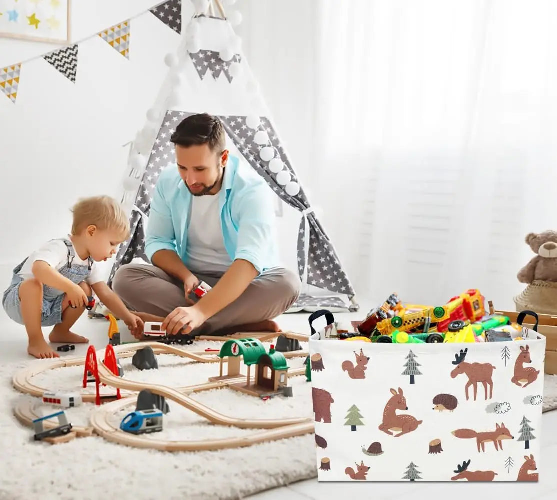 A man is assembling a foldable fabric storage basket with handles for organizing toys on a white rug.