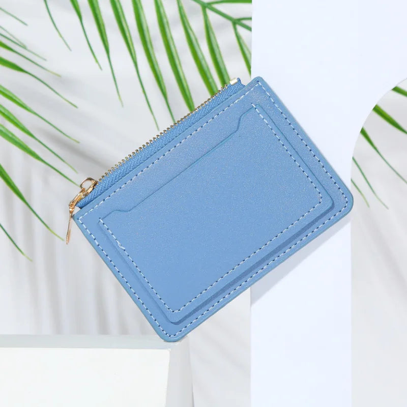 A light blue PU leather mini card holder wallet with a silver zipper shown against a white background.