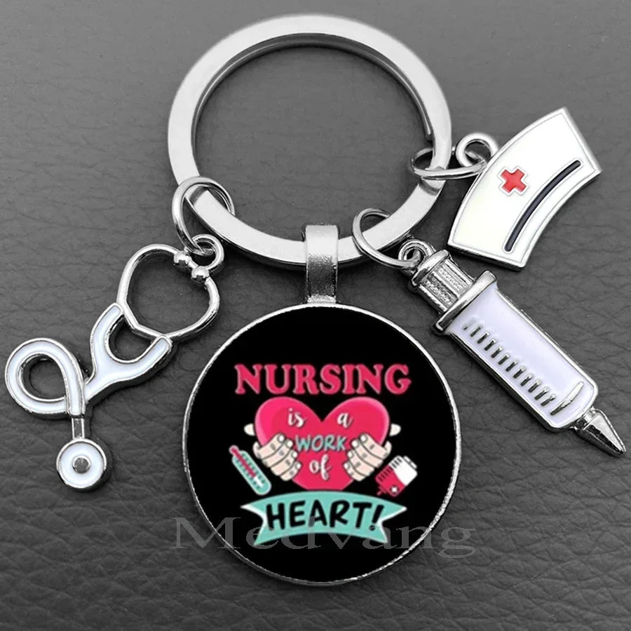 Silver keychain featuring a stethoscope charm and a circular pendant with the text Nursing is a work of heart