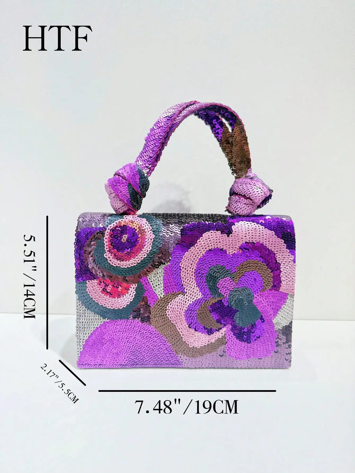 A purple sequin embroidered floral clutch bag with a purple strap and intricate floral designs.