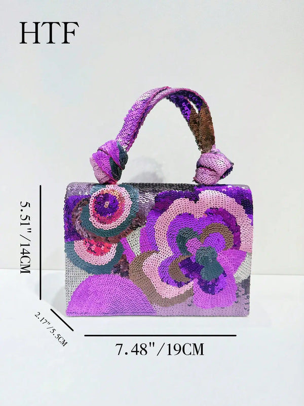 A purple sequin embroidered floral clutch bag with a purple strap and intricate floral designs.