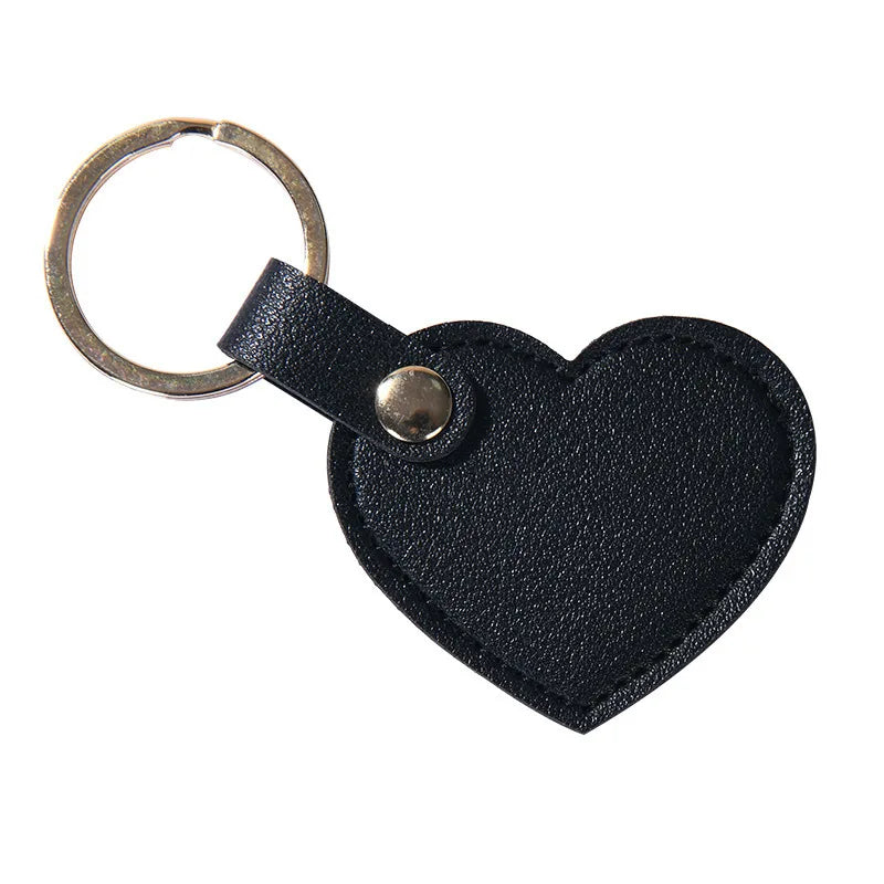 A black leather heart-shaped keychain with a metal ring and clasp.