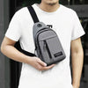 A person wearing a white t-shirt holds a gray water-resistant casual chest bag with a phone pocket.