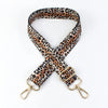 A leopard print adjustable crossbody strap made of brown and black animal print leather.