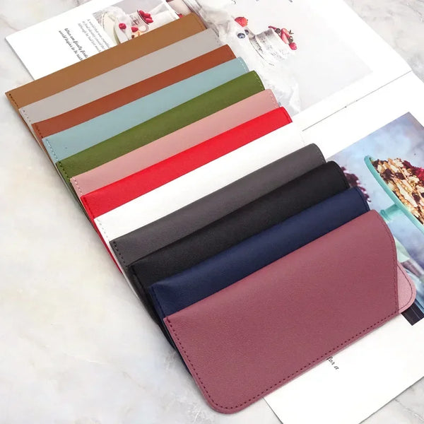 A collection of PU leather eyewear cases in various shades of brown, green, pink, and blue displayed on a white background.