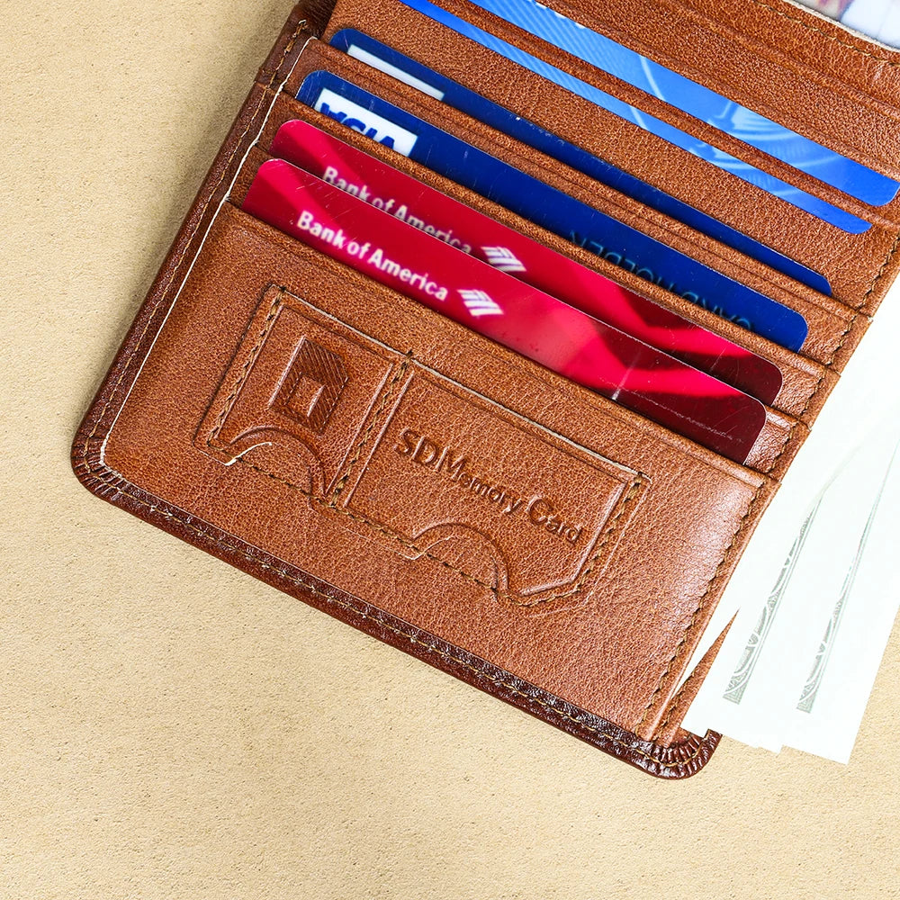 A brown genuine leather bifold wallet showing various credit cards and an SD memory card.