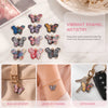 A set of vibrant enamel butterfly charms used for bespoke jewelry creation, displayed alongside finished keychains and access