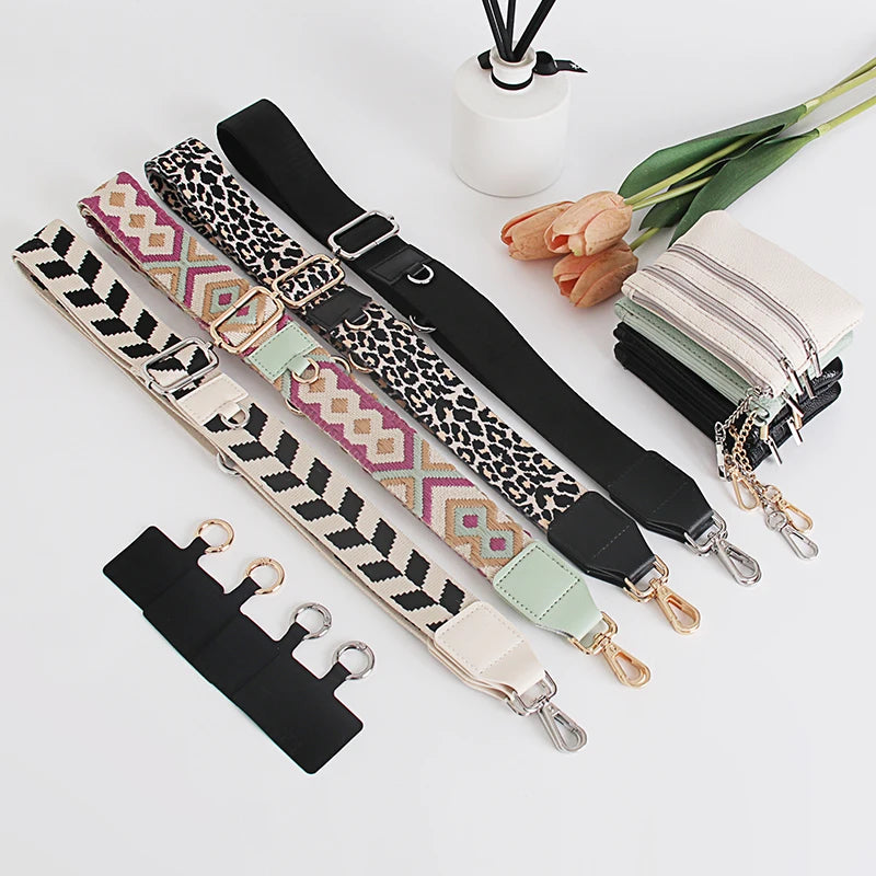 A collection of black and patterned phone lanyards with detachable leather wallets and a white cylindrical object.