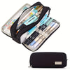 A black pencil case filled with various colored pencils and pens, including a yellow and blue labeled box.
