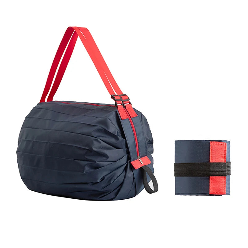 A navy blue foldable nylon storage bag with red straps and a black elastic band is shown.