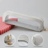 A clear, rectangular cosmetic organizer pouch with a white frame and gold hardware shown from multiple angles.