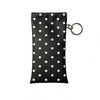 Black polka dot eyeglass pouch with a silver keychain attached.